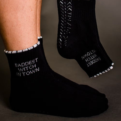 Black socks with text and Treads branding on a dark background