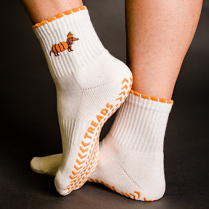 White socks with orange accents and a tiger design on a dark background