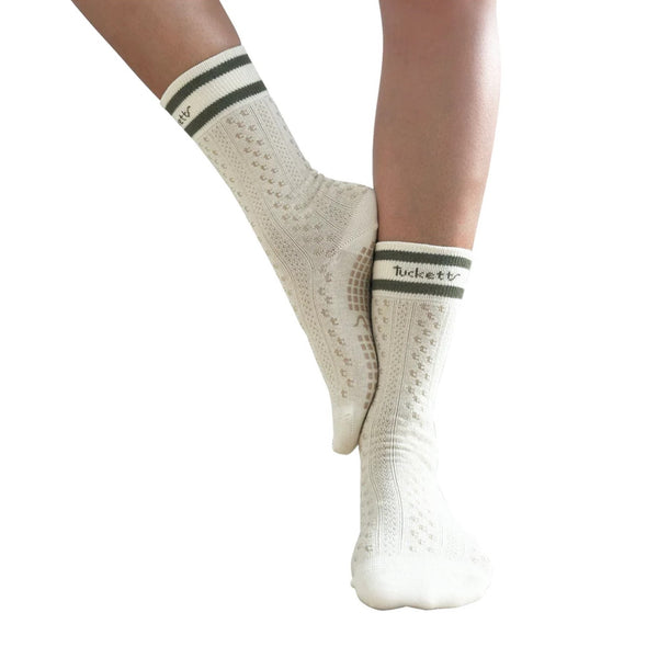White socks with black stripes worn by a person on a white background