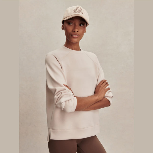 Woman wearing an ivory crewneck